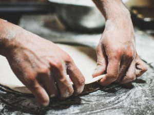 An image laying out pizza dough